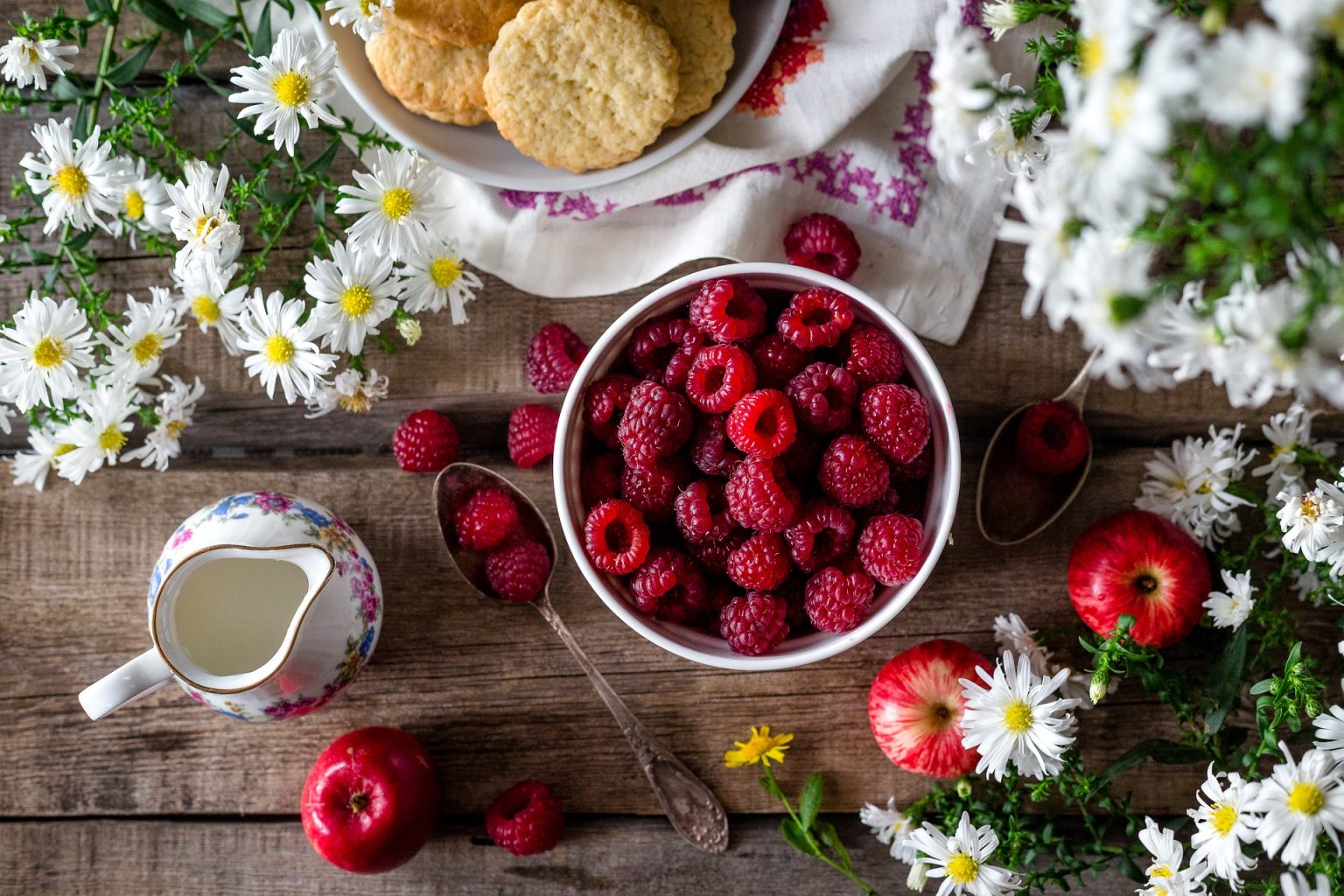 An image with fruits and flower on the table