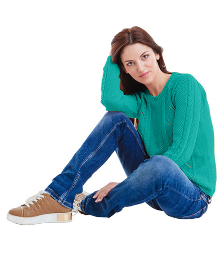 woman in sea green sweatshirt & jeans